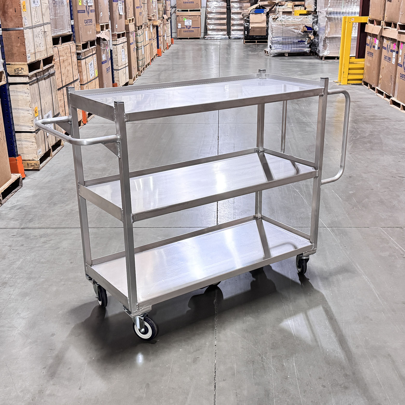 Retail stock cart with durable aluminum frame, smooth rolling casters, and ergonomic push handles.