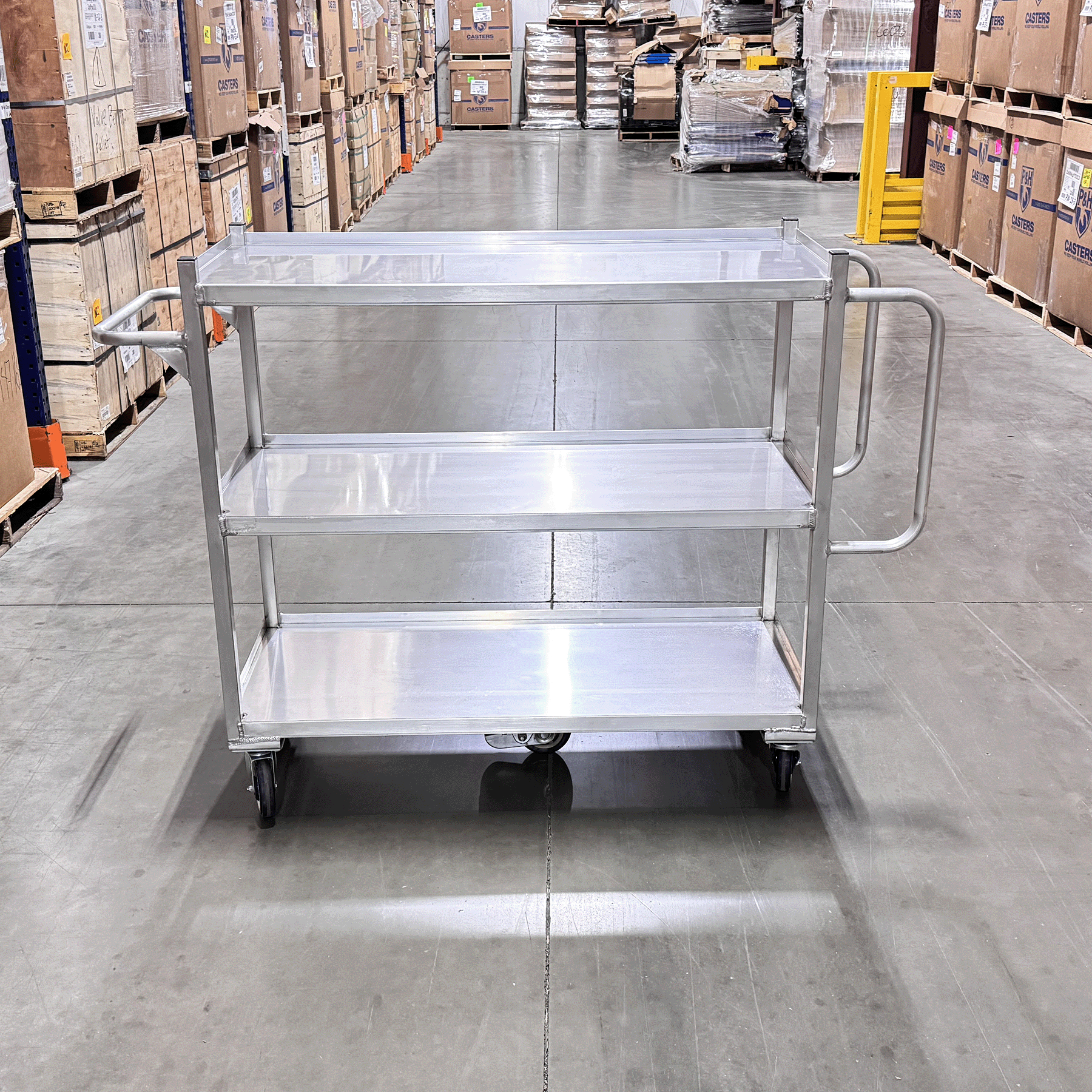 Retail stock cart with durable aluminum frame, smooth rolling casters, and ergonomic push handles.